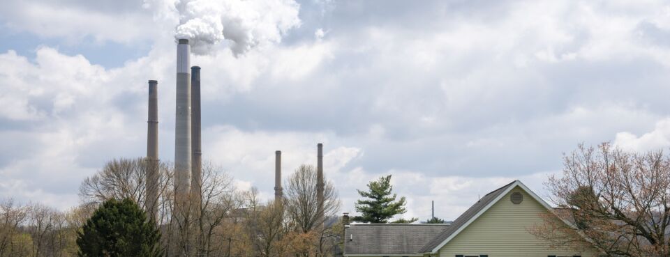A home stands in front of the Conesville Power Plant in Conesville